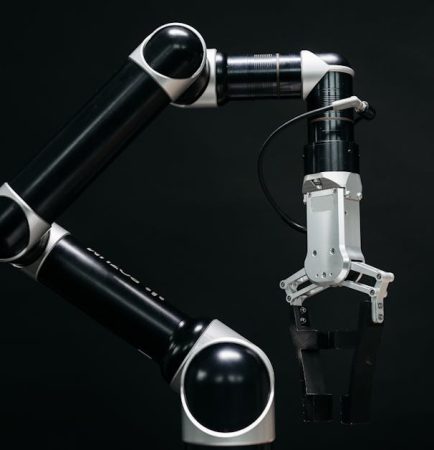 Close-up of a mechanical robotic arm with a dark background, showcasing advanced technology.