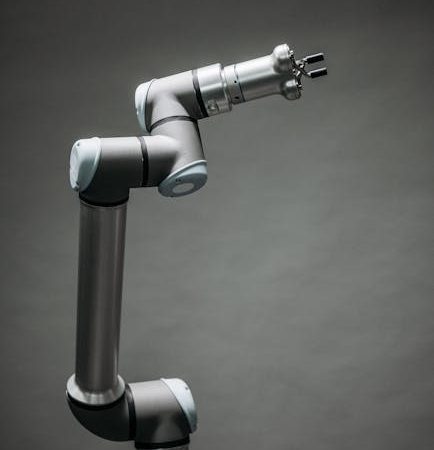 An industrial robotic arm on a neutral background, showcasing modern technology and innovation.