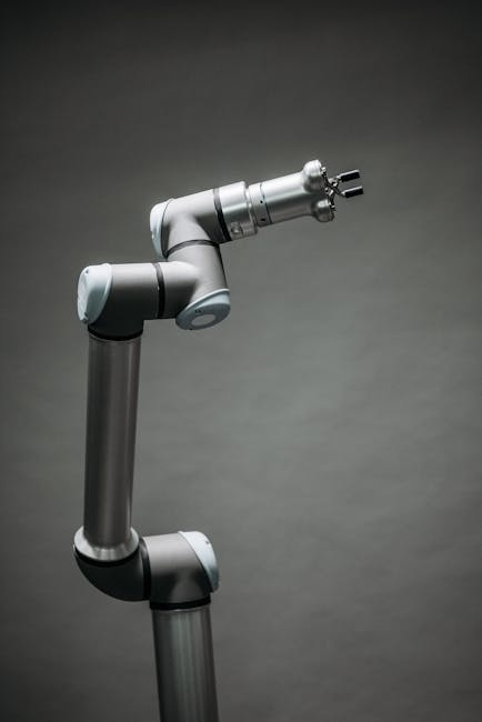 An industrial robotic arm on a neutral background, showcasing modern technology and innovation.