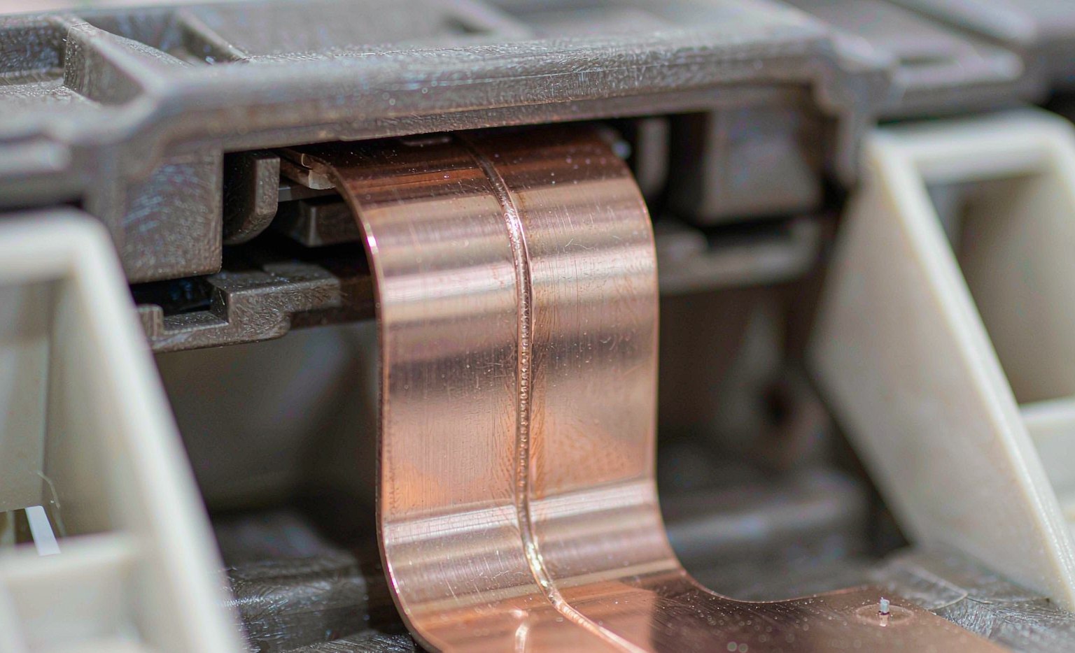Laser Welding Robots in EV Battery Manufacturing Close-up of a laser weld on a copper busbar of an EV battery module
