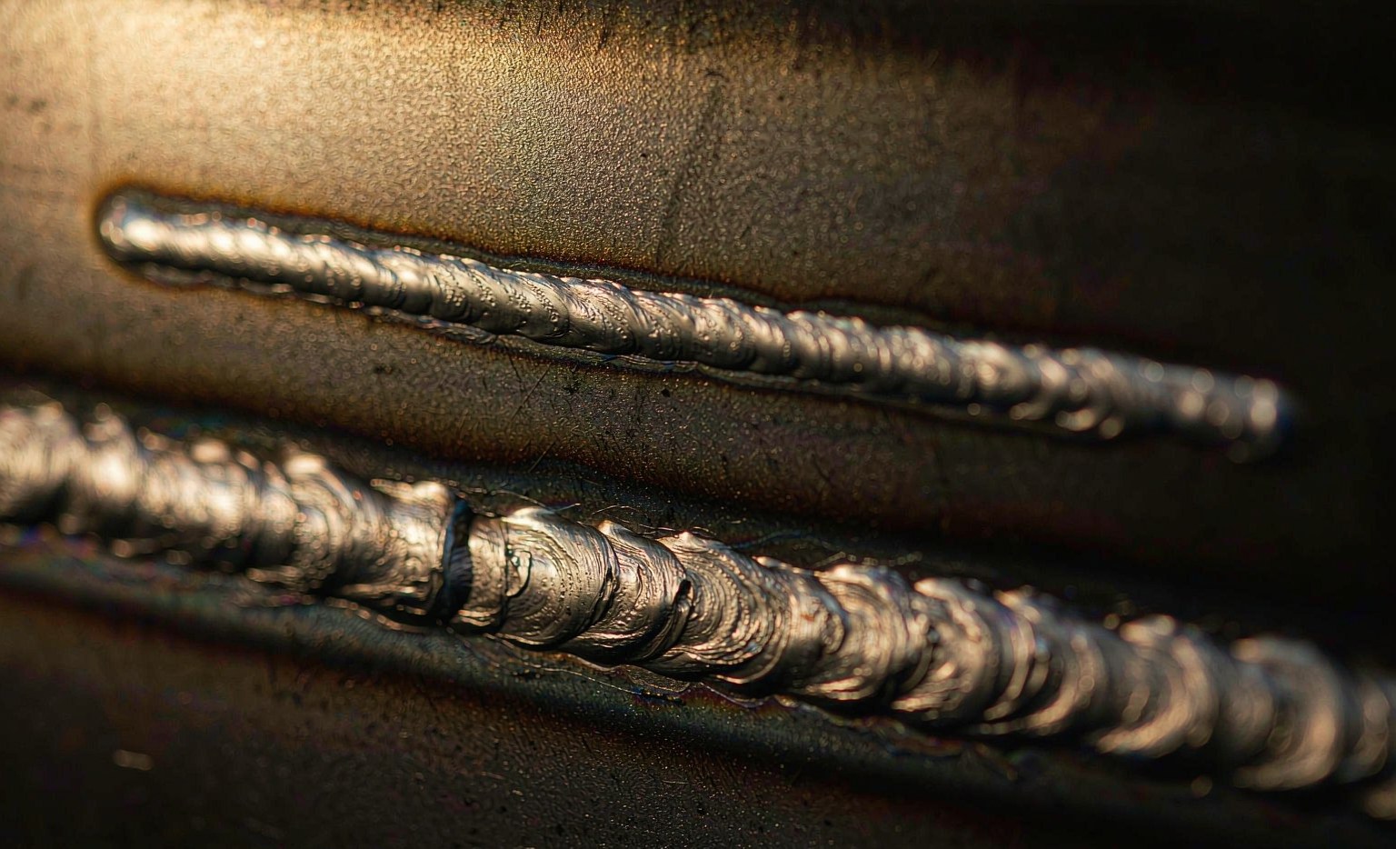 Laser Welding vs TIG/MIG: Speed, Heat Input and Distortion Cross-section samples of a narrow laser weld and a wider MIG weld
