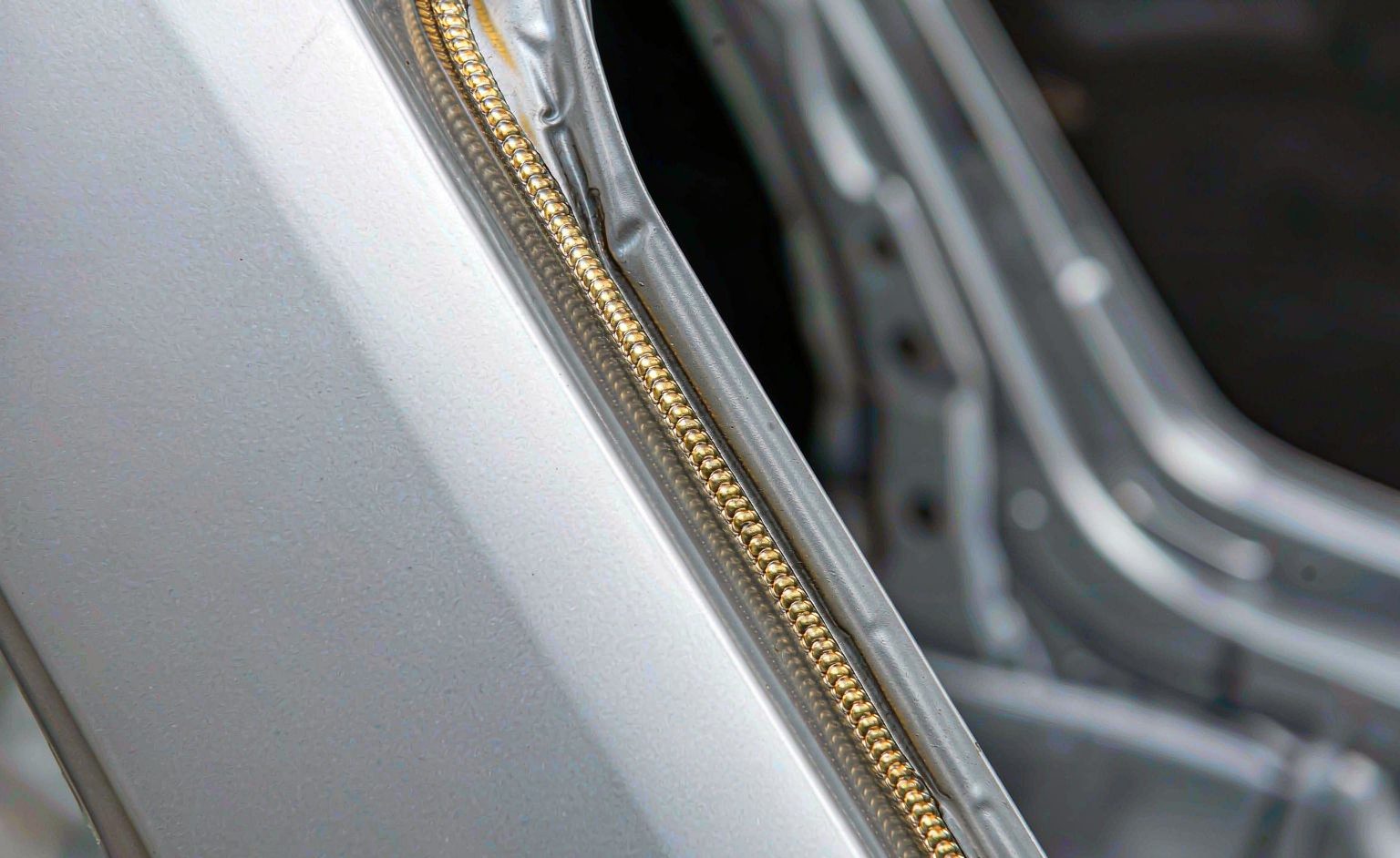 Soldadura por láser en la industria automotriz: Aplicaciones, portagavetas y economía de ciclo Brazo de soldadura robótica por láser soldando un bastidor de carrocería en una línea de producción automotriz