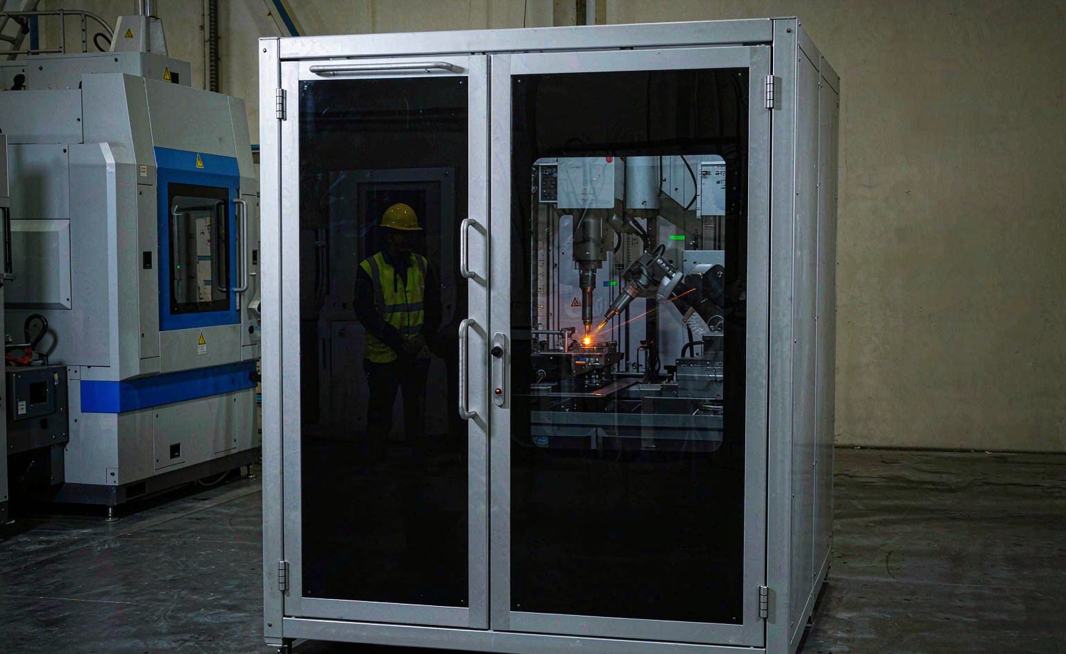 Celda de soldadura láser de Clase 4 cerrada con puerta de acceso con enclavamiento y ventana de observación